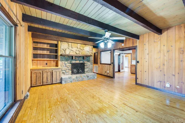 a view of a room with wooden floor
