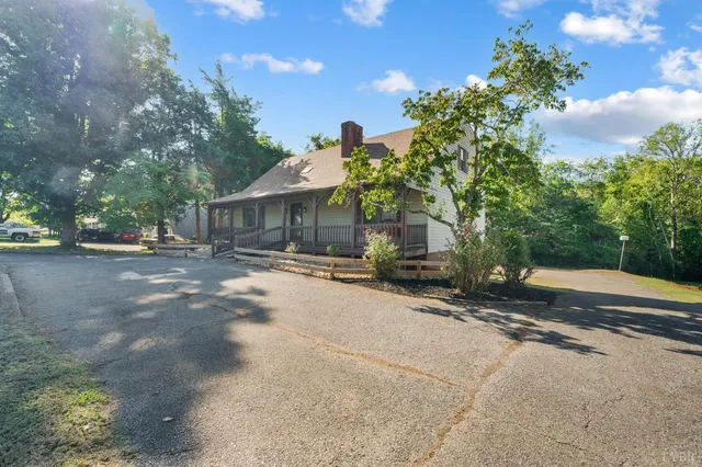an aerial view of a house with swimming pool and furniture