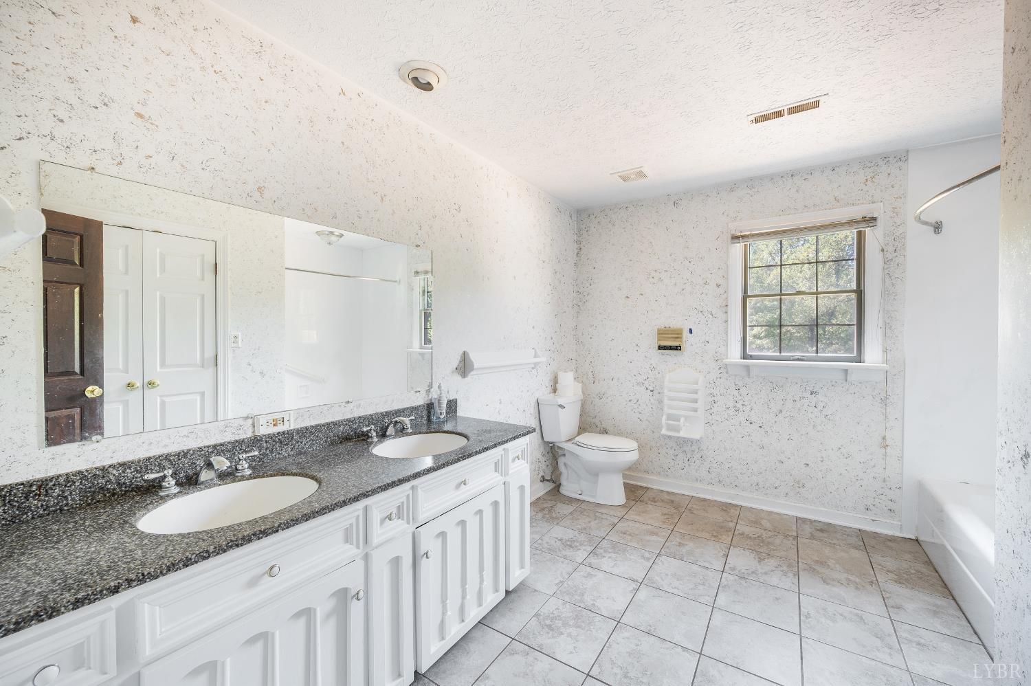 1139 Macon Loop Lynchburg, VA 24503 - Photo 36 of 63 a bathroom with a granite countertop double vanity sink a mirror and a toilet