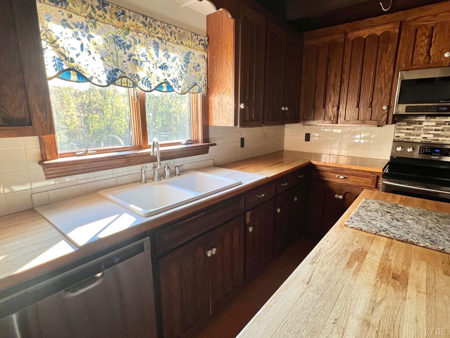 1139 Macon Loop Lynchburg, VA 24503 - Photo 47 of 63 a kitchen with a sink stove top oven and cabinets