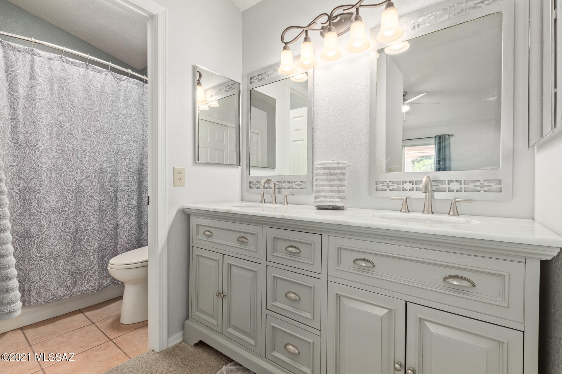 3034 West Sky Ranch Trail Tucson, AZ 85742 - Photo 16 of 27 a bathroom with a double vanity sink mirror and toilet