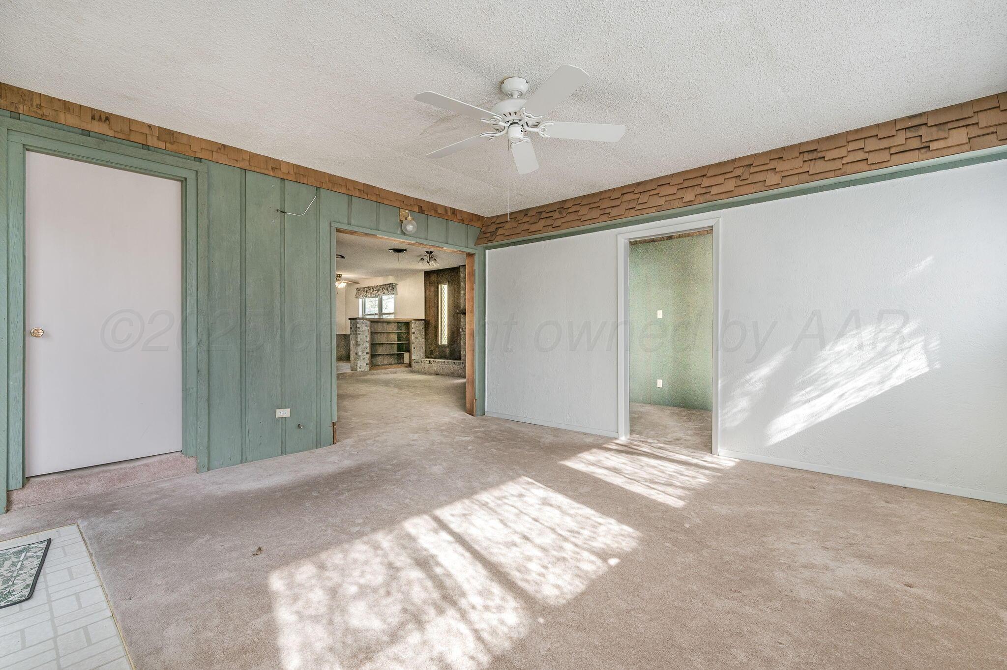 4701 Mesa Circle Amarillo, TX 79109 - Photo 11 of 20 a view of a hallway with a chandelier fan and windows