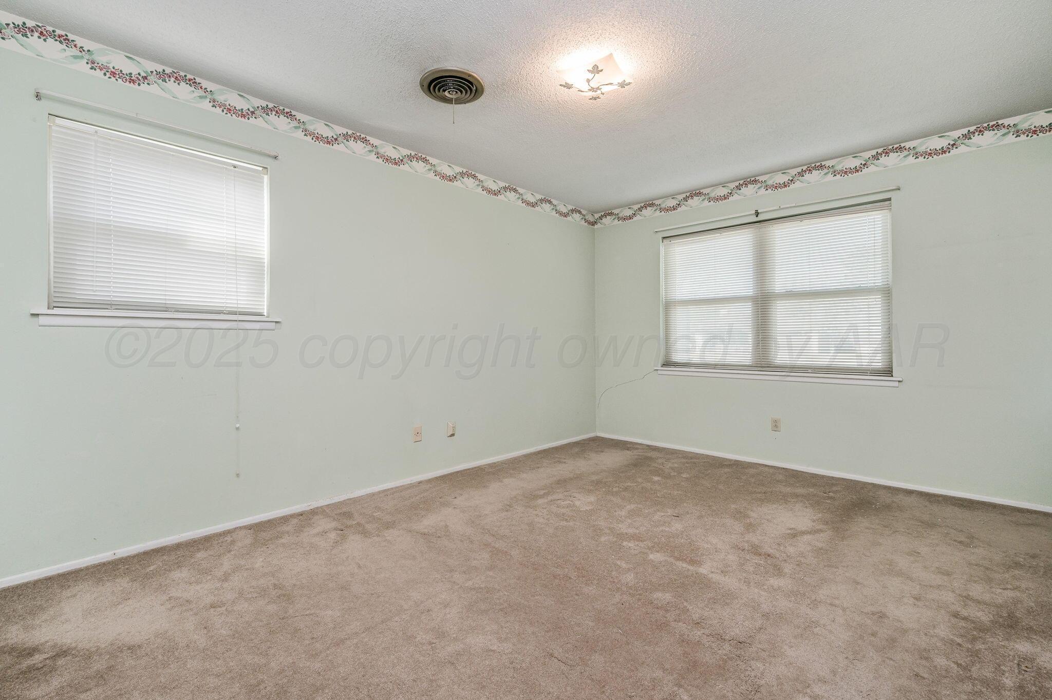 4701 Mesa Circle Amarillo, TX 79109 - Photo 13 of 20 an empty room with windows and closet