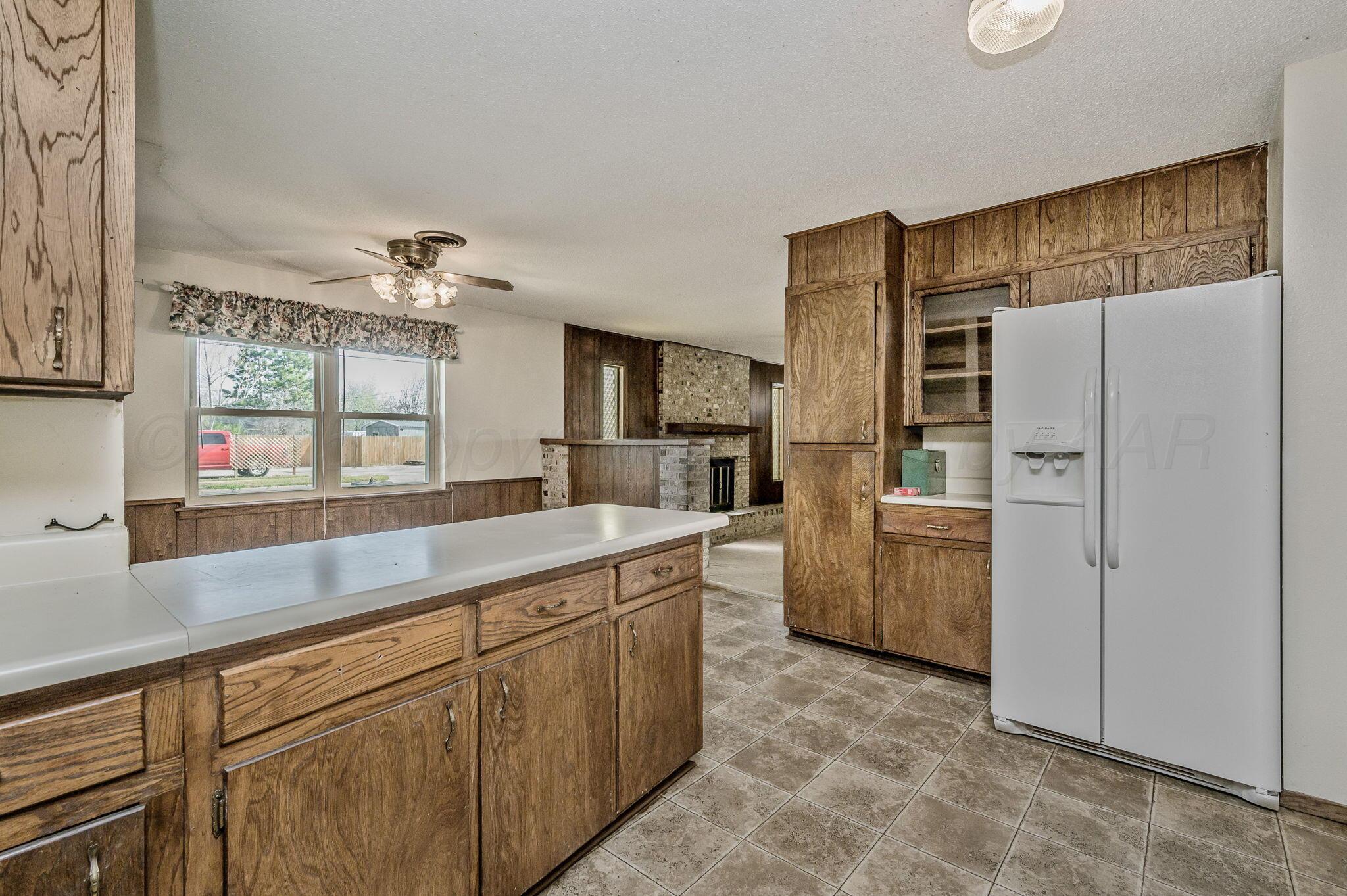 4701 Mesa Circle Amarillo, TX 79109 - Photo 6 of 20 a kitchen with a refrigerator and a sink