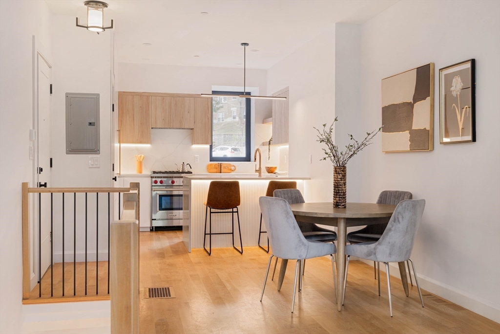 a dining room with furniture and wooden floor