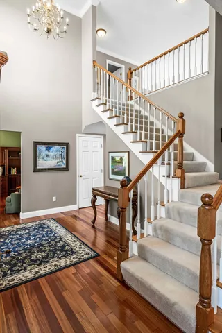 a kitchen with stainless steel appliances granite countertop a kitchen island hardwood floor and a sink