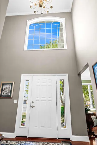 a living room with furniture a window and a potted plant