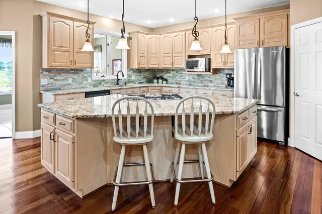 a living room with furniture and floor to ceiling windows