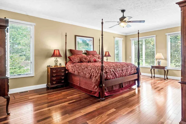 a view of a living room with furniture and wooden floor