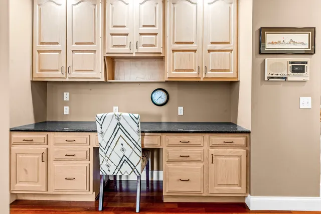a en suite bathroom with a granite countertop sink and a mirror