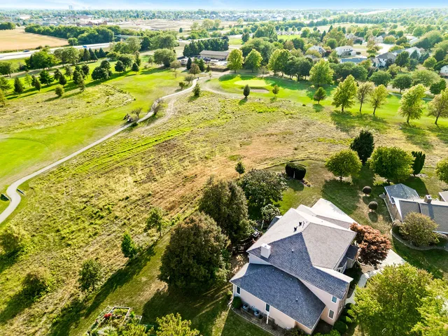 a kitchen with stainless steel appliances granite countertop a refrigerator a stove and white cabinets with wooden floor