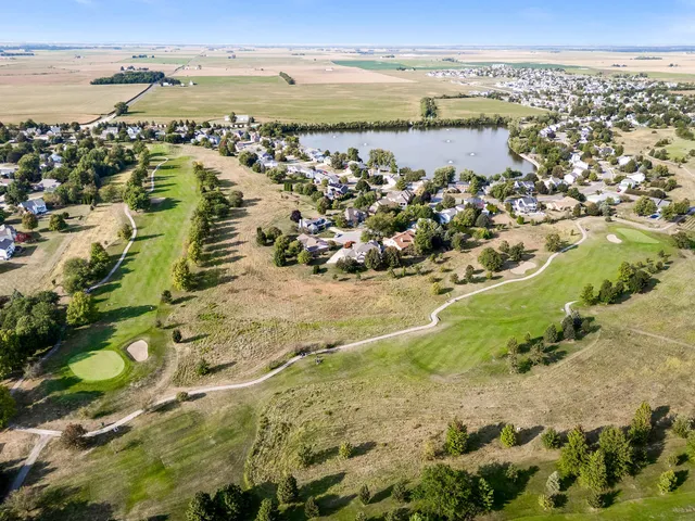 a kitchen with stainless steel appliances granite countertop a kitchen island hardwood floor and a sink