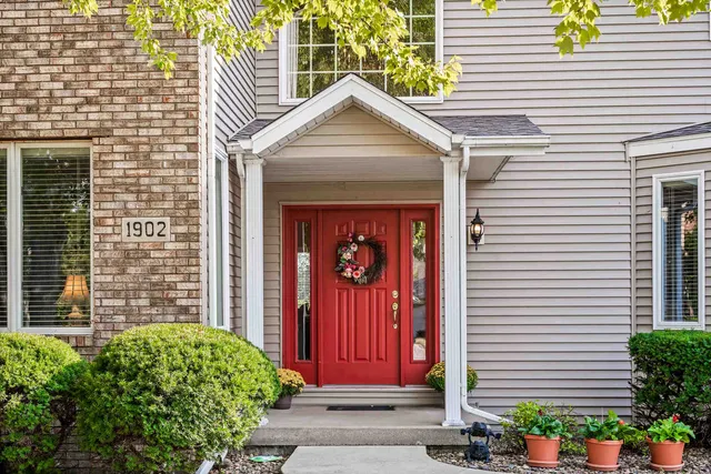 a kitchen with stainless steel appliances granite countertop a stove top oven a refrigerator a sink and dishwasher with wooden floor