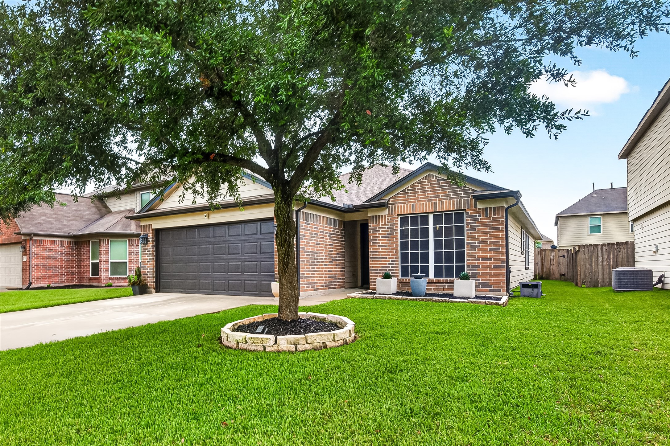3155 View Valley Trail Katy, TX 77493 - Photo 2 of 50 An alternative front view showcasing the pristine brick exterior, framed by lush green grass and a mature tree for added shade and charm