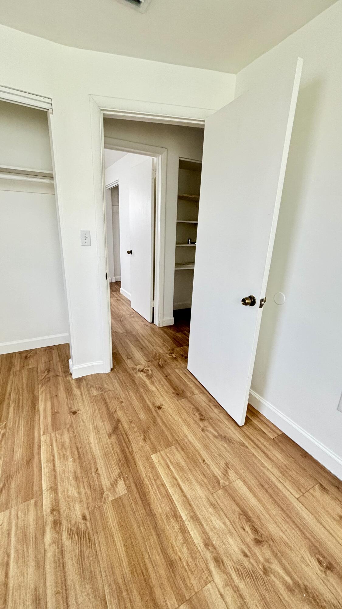 3945 Ocala Road Lake Worth, FL 33462 - Photo 11 of 18 a view of a room with wooden floor and white doors
