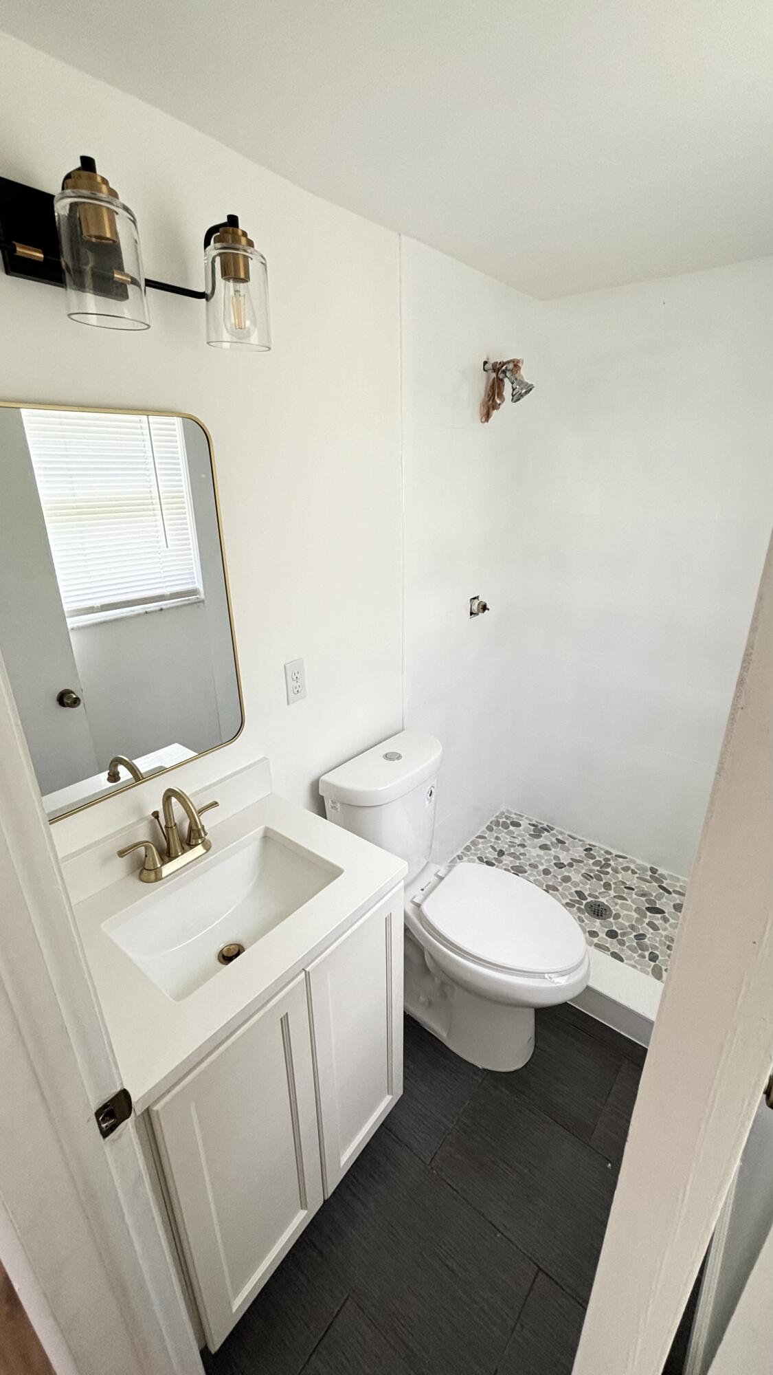 3945 Ocala Road Lake Worth, FL 33462 - Photo 14 of 18 a bathroom with a sink toilet and mirror