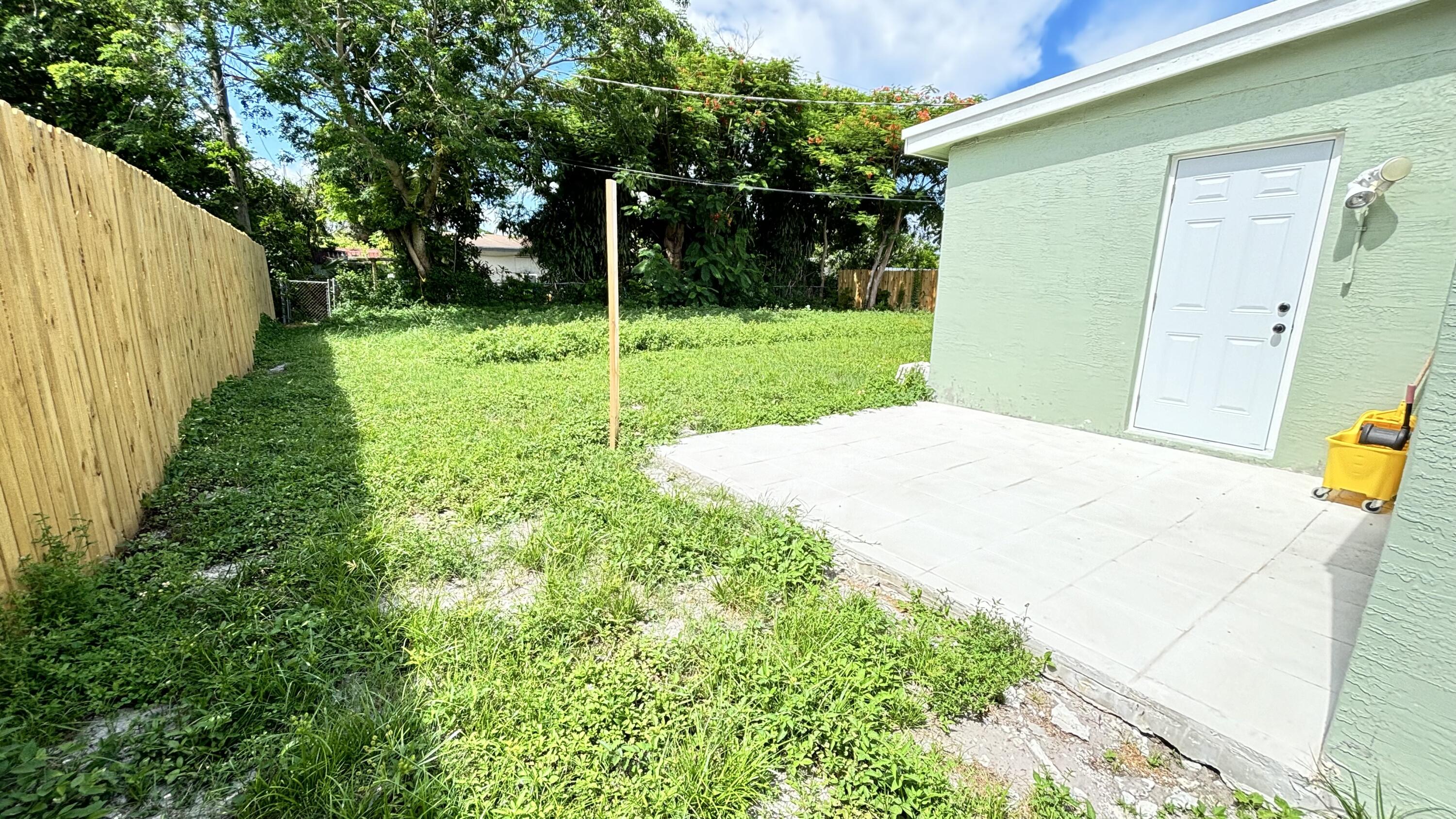 3945 Ocala Road Lake Worth, FL 33462 - Photo 16 of 18 a view of a backyard with potted plants