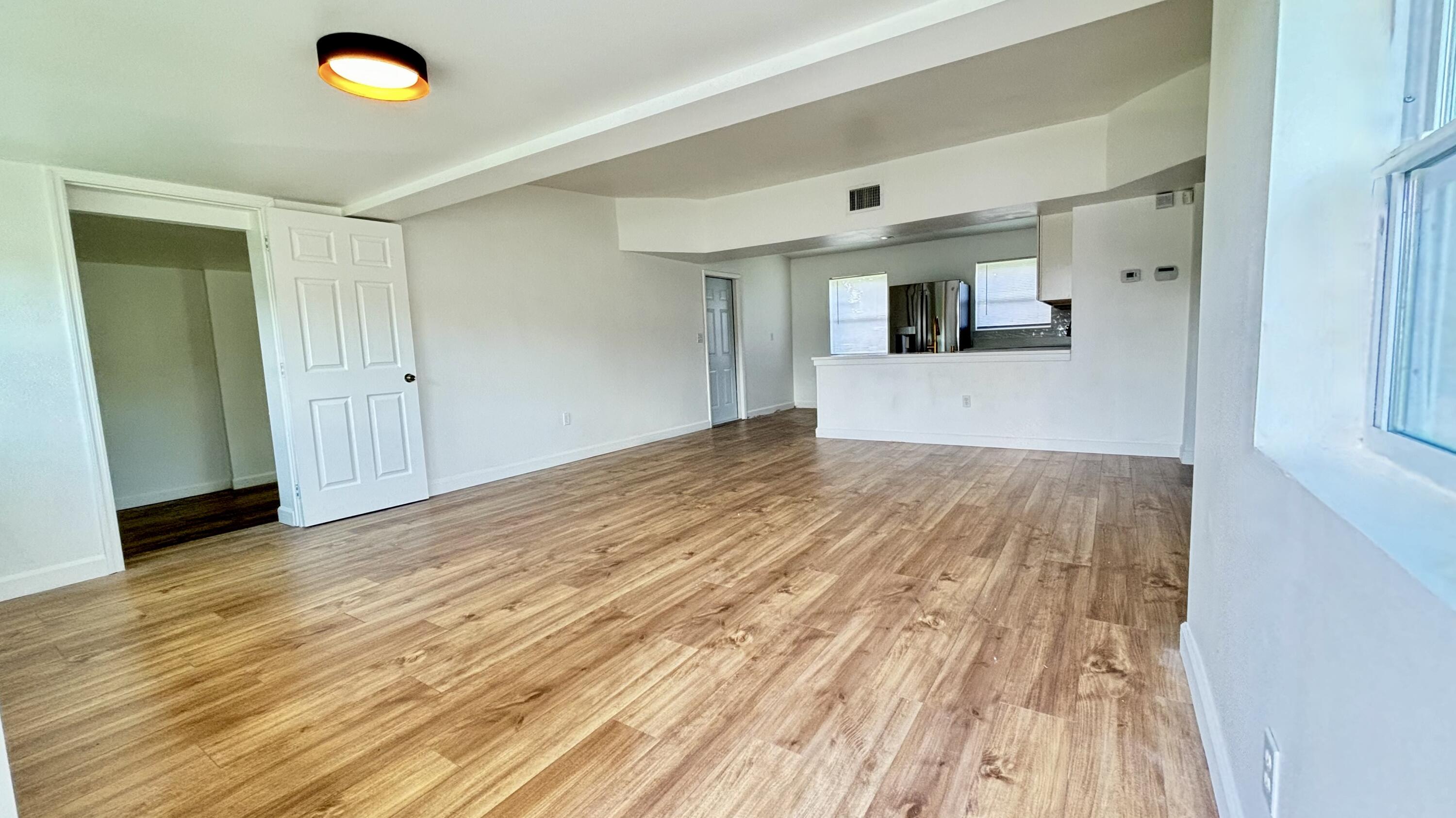 3945 Ocala Road Lake Worth, FL 33462 - Photo 2 of 18 a view of empty room with wooden floor and fan