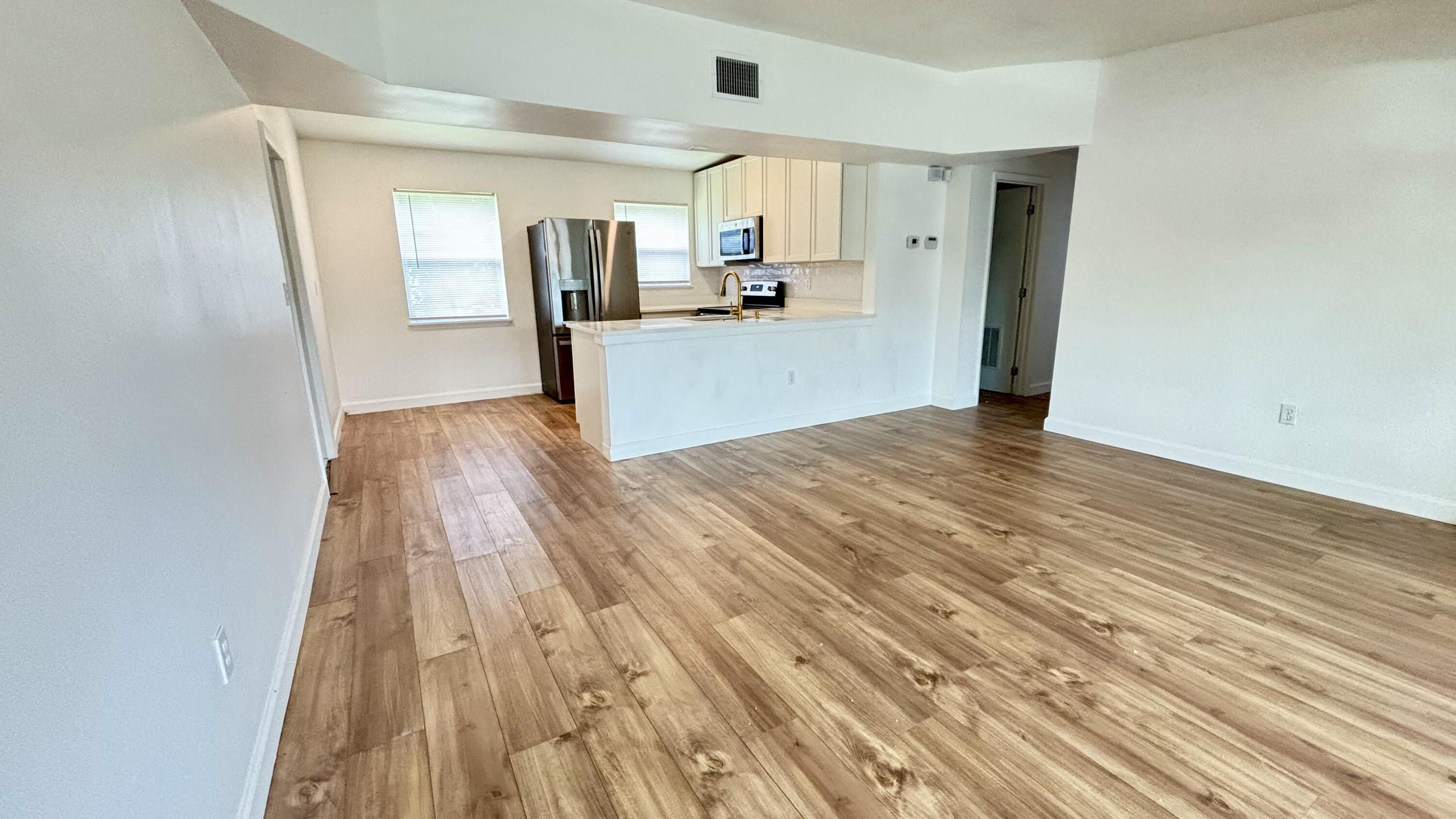 3945 Ocala Road Lake Worth, FL 33462 - Photo 3 of 18 a view of a kitchen from a hallway