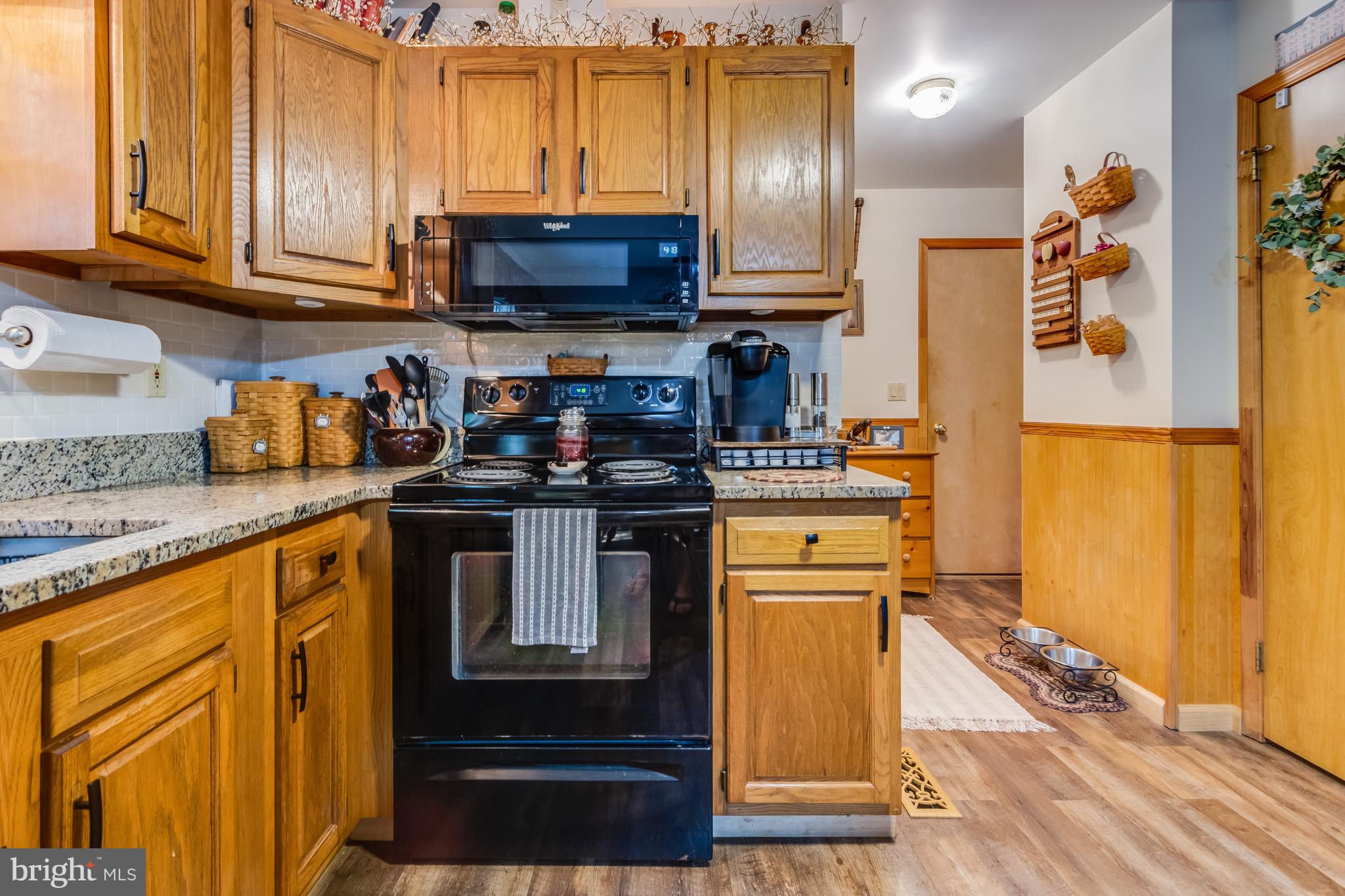 30064 West Mill Run Milton, DE 19968 - Photo 17 of 42 a kitchen with stainless steel appliances granite countertop a stove a sink and a refrigerator