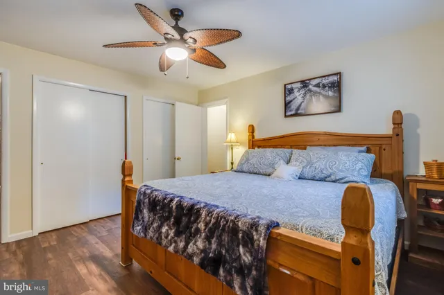 a bedroom with bed and wooden floor