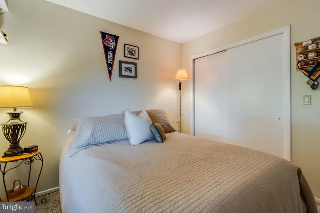 a bedroom with a bed and a lamp on table