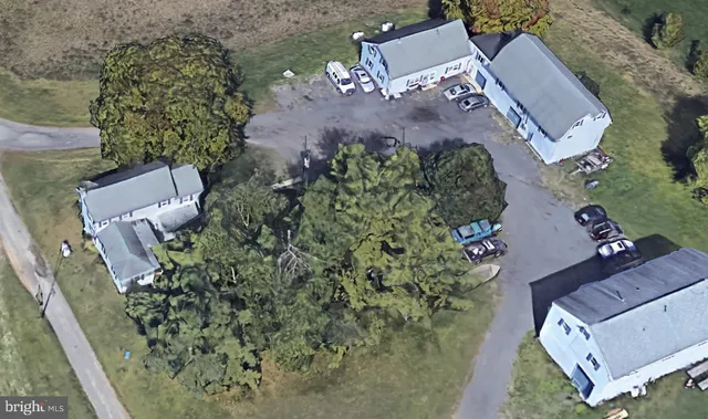 an aerial view of a house with a yard and trees