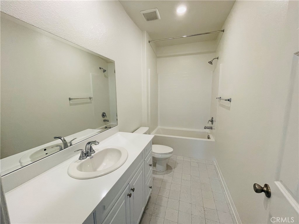 19770 Barnfield Place Riverside, CA 92507 - Photo 14 of 22 a bathroom with a sink toilet and shower