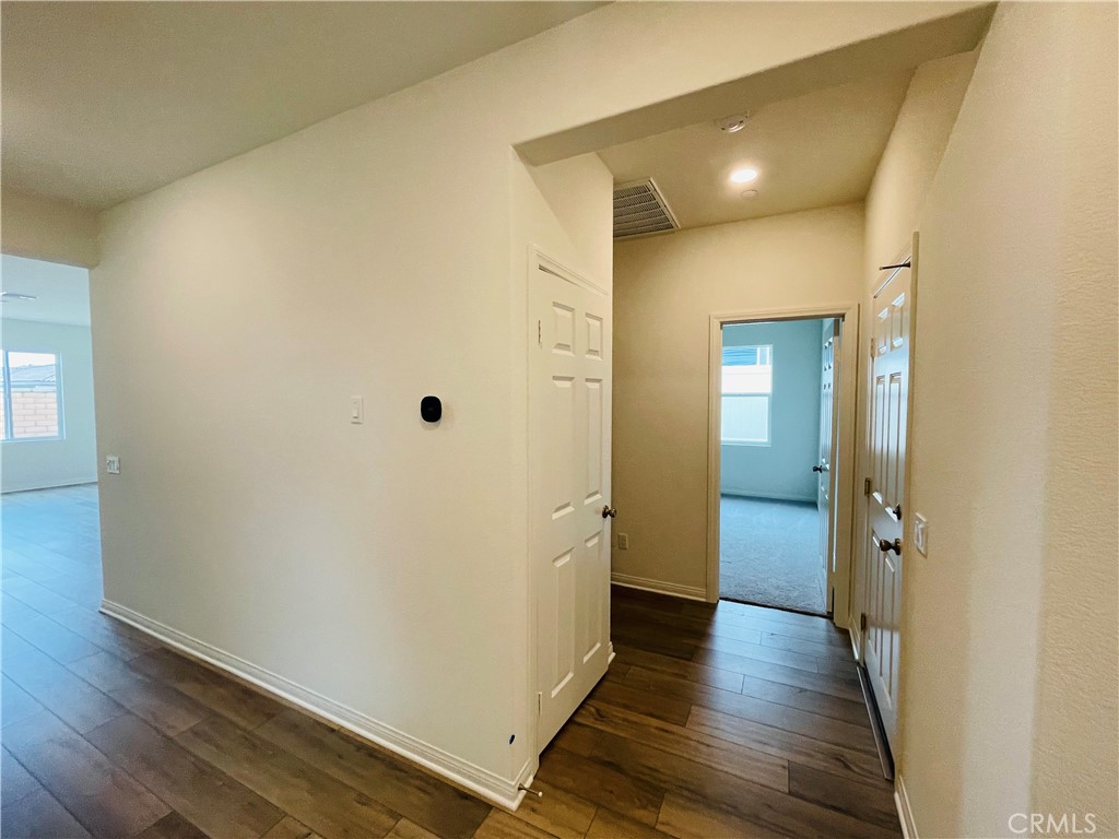 19770 Barnfield Place Riverside, CA 92507 - Photo 15 of 22 a view of a hallway with wooden floor