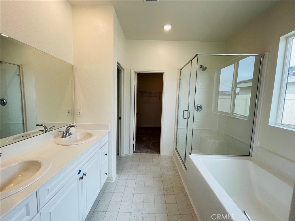 19770 Barnfield Place Riverside, CA 92507 - Photo 19 of 22 a spacious bathroom with a tub sink shower and mirror