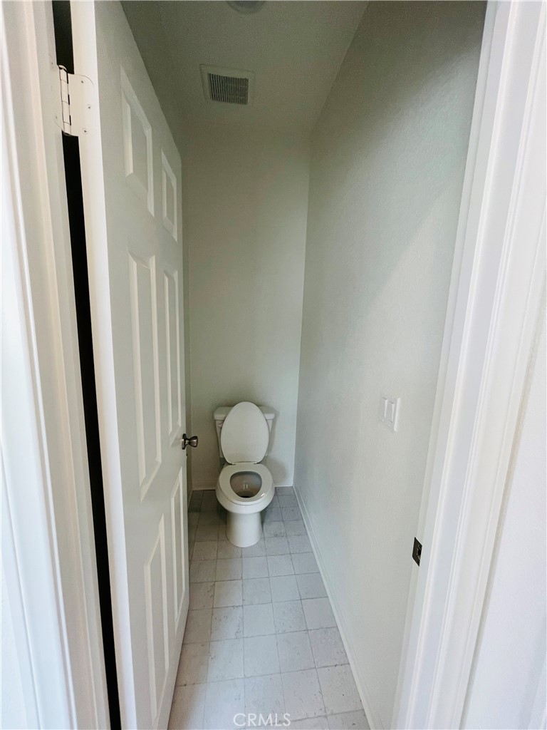 19770 Barnfield Place Riverside, CA 92507 - Photo 21 of 22 a bathroom with a toilet and a sink