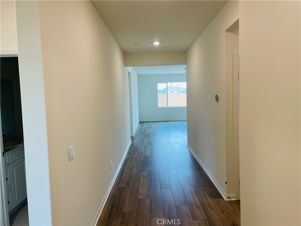 19770 Barnfield Place Riverside, CA 92507 - Photo 3 of 22 a view of a hallway with wooden floor