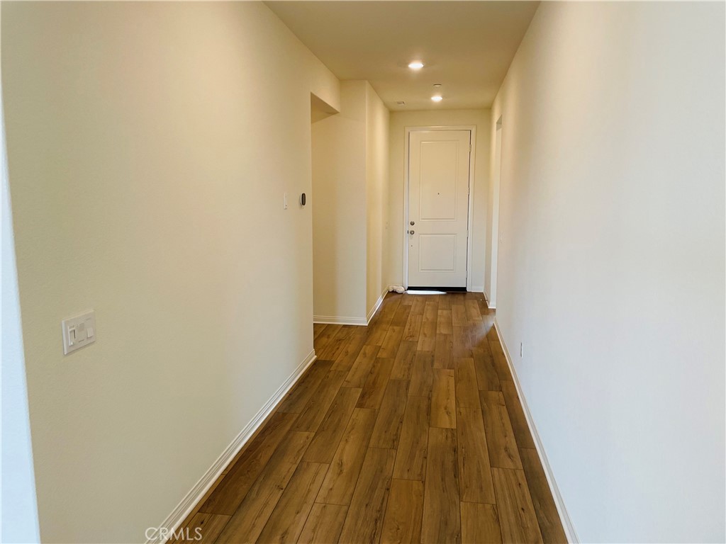 19770 Barnfield Place Riverside, CA 92507 - Photo 4 of 22 a view of a hallway with wooden floor