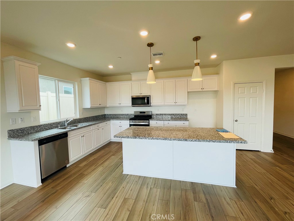 19770 Barnfield Place Riverside, CA 92507 - Photo 6 of 22 a large kitchen with stainless steel appliances granite countertop a stove a sink and a refrigerator