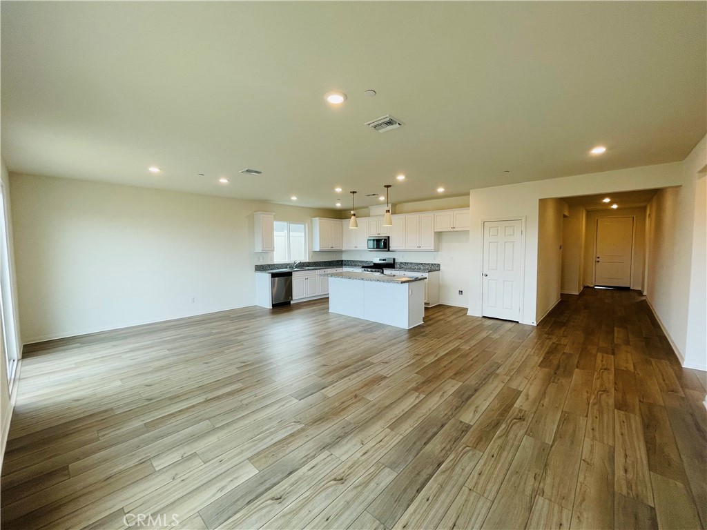 19770 Barnfield Place Riverside, CA 92507 - Photo 7 of 22 a view of kitchen with kitchen island wooden floor and center island