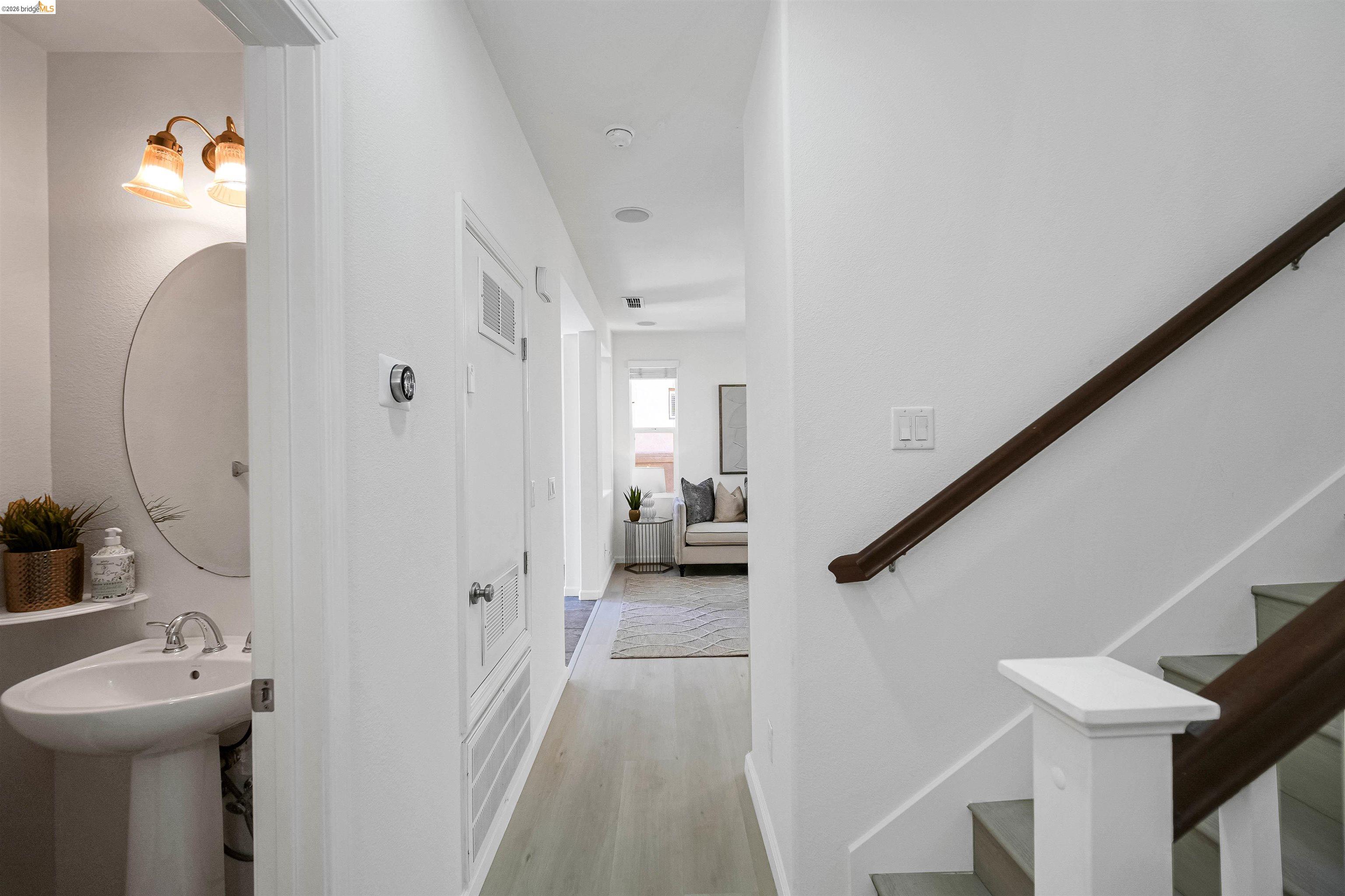 449 Constantine Court San Ramon, CA 94583 - Photo 32 of 63 Hallway featuring wood-finish flooring, recessed lighting, and a staircase with a dark wood handrail and white newel post