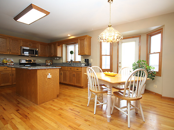 2107 High Meadow Road Naperville, IL 60564 - Photo 8 of 25 a dining table chairs and a kitchen view