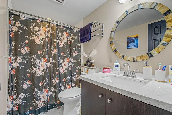 a bathroom with a sink vanity and toilet