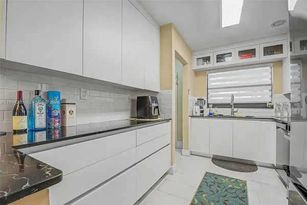 a kitchen with stainless steel appliances granite countertop a sink and a stove