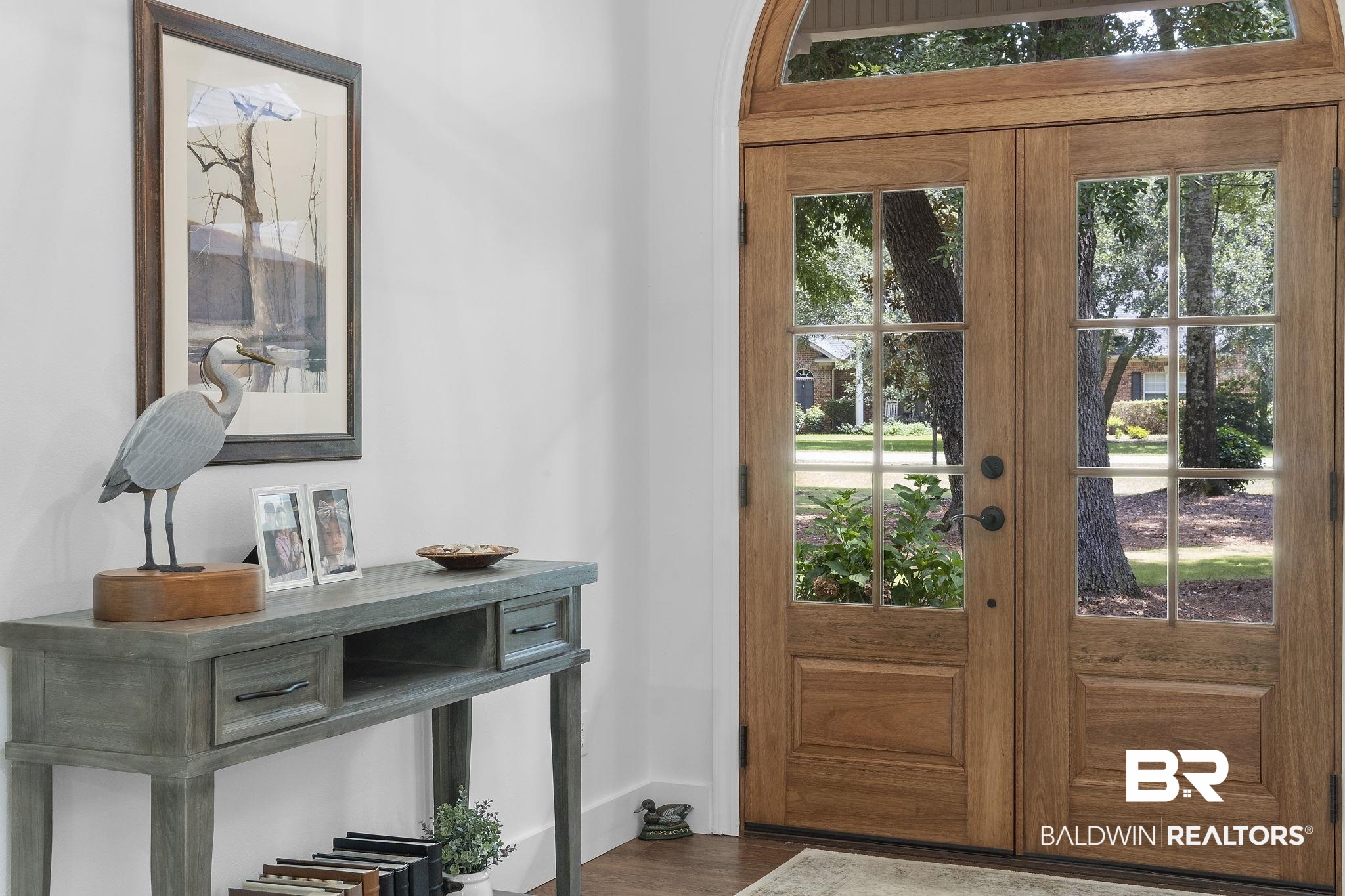 4451 Millhouse Road Gulf Shores, AL 36542 - Photo 6 of 50 Doorway to outside featuring hardwood / wood-style flooring
