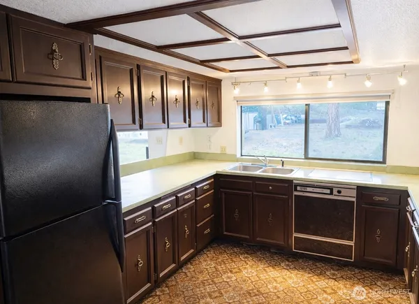 a kitchen with a sink and large window