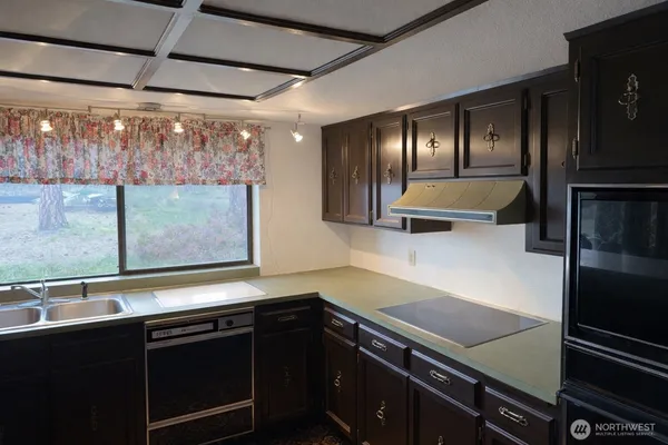 a kitchen with a sink and cabinets
