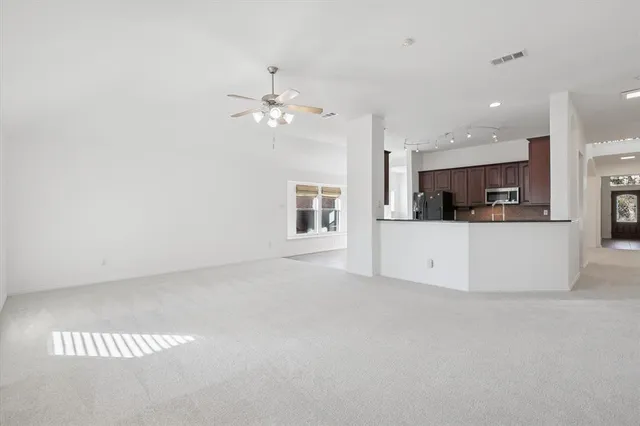 a view of a kitchen with furniture and a ceiling fan