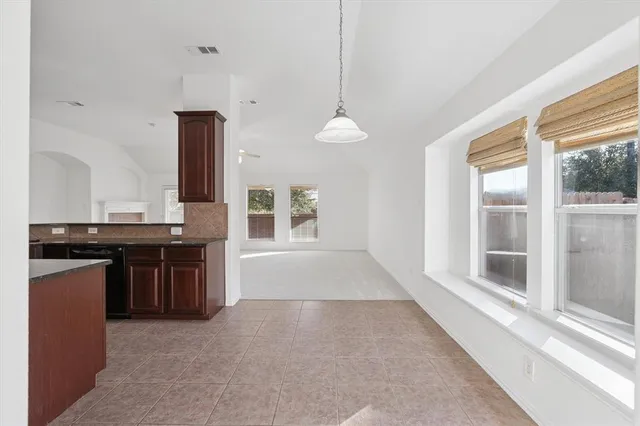 a large kitchen with kitchen island a counter space a sink and a window