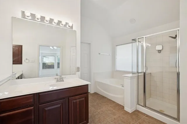 a bathroom with a double vanity sink mirror and shower