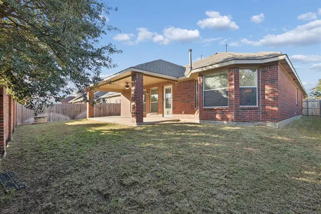 a view of a house with a backyard