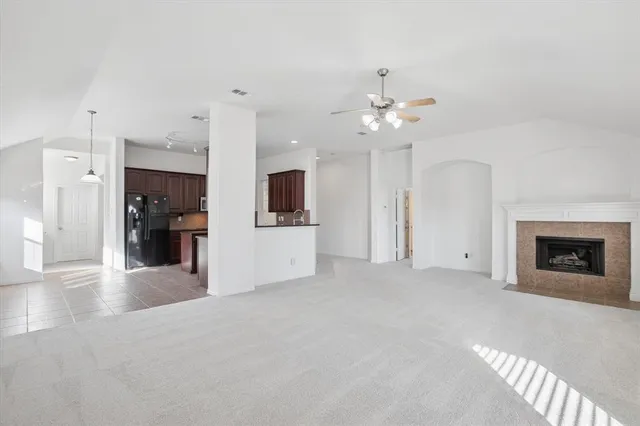 a view of a kitchen with a sink & a fireplace