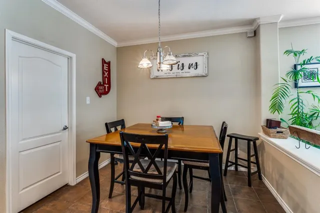 a view of a dining room with furniture and chandelier