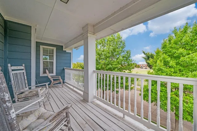a view of a two chairs in the balcony