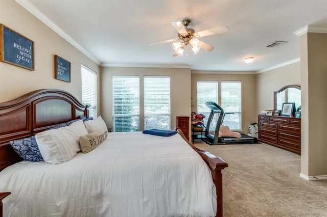 a bedroom with furniture and a large window